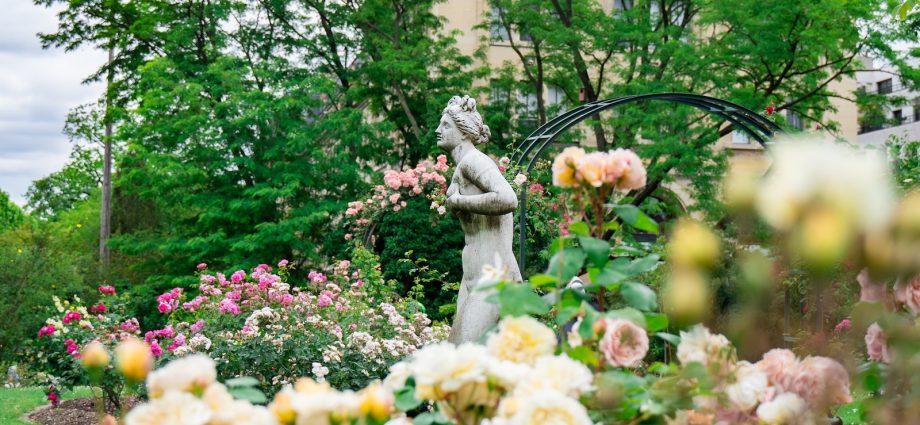 woman statue near plants and trees