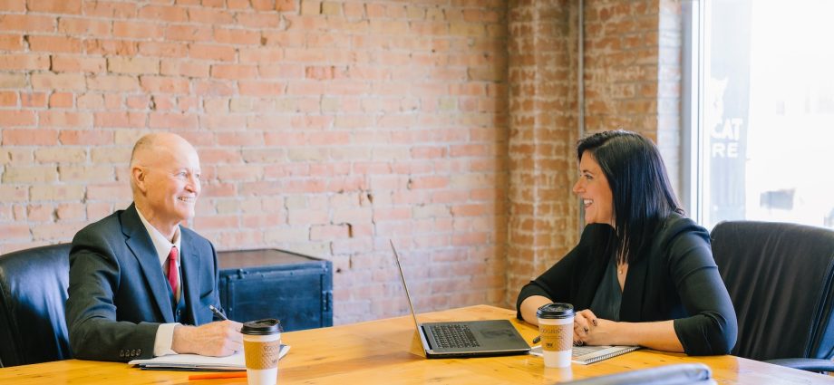 man and woman talking inside office