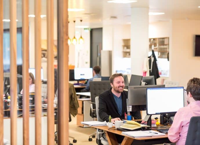 a man sitting at a desk in an office